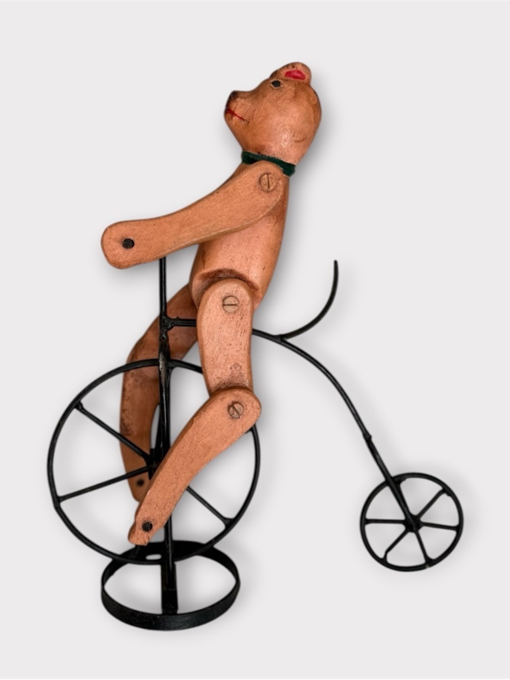 Vintage antique folk Art hand carved wooden bear on metal bicycle